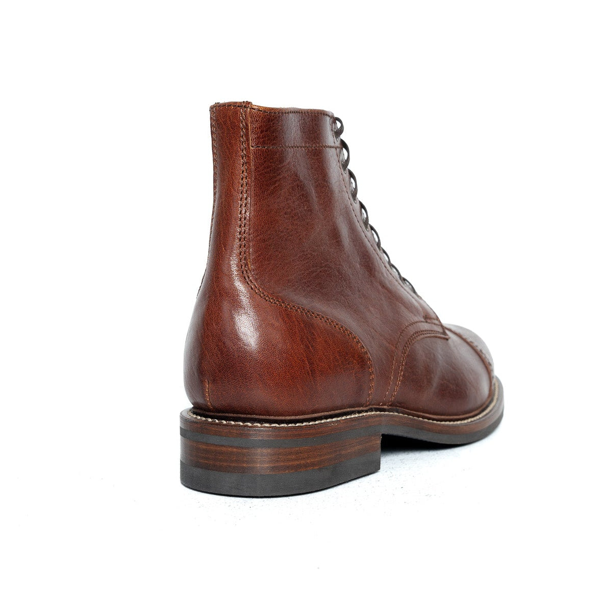 A single brown leather lace-up ankle boot shown from a rear three-quarter angle on a plain white background.